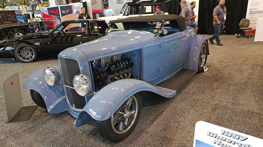 Located in the SEMA HRIA (Hot Rod Industry Alliance) booth was Scott and Stephanie Movic’s gorgeous 1932 Ford Roadster built by Ace Fabrication in Clever, Missouri. This is the type of build that doesn’t seem look complicated, but the more you look at it, the more subtle details you see. It’s TREMEC equipped with a Bowler Performance TKX 5-speed transmission behind its Chevrolet Performance LS3 crate engine. That 430 horsepower might seem ho-hum these days, but in a car weighing just above 2,000 pounds it makes a lopsided power-to-weight ratio that makes this roadster a rocket. The color is PPG Porsche Aetna Blue. It has a stretched wheelbase, lengthened hood and relocated gas tank. 