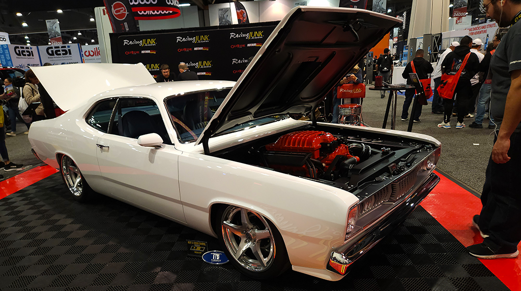 Parked in the Racing Junk booth was this killer 1971 Plymouth Duster built by BBT Fabrications. It features a custom-built full frame, with a supercharged Hellcat Hemi V8 crate engine and Bowler Performance TREMEC Magnum 6-speed transmission. We love the blue leather interior paired with the white exterior. 