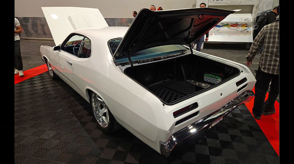 Parked in the Racing Junk booth was this killer 1971 Plymouth Duster built by BBT Fabrications. It features a custom-built full frame, with a supercharged Hellcat Hemi V8 crate engine and Bowler Performance TREMEC Magnum 6-speed transmission. We love the blue leather interior paired with the white exterior. 