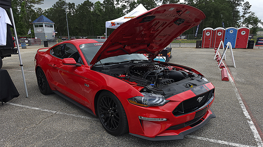 A red with black stripes 2018 Ford Mustang GT with a VMP Performance supercharger installed on its 5.0L Coyote V8 that was used by TREMEC Transmissions to test its updated Magnum XL six-speed for use in S550 Mustangs