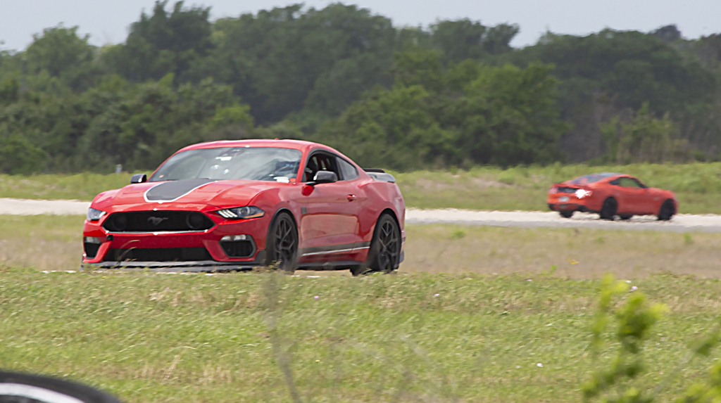 A Ford S550 Mach 1 Mustang races on a road course in Texas during Mustang Week Texas 2026