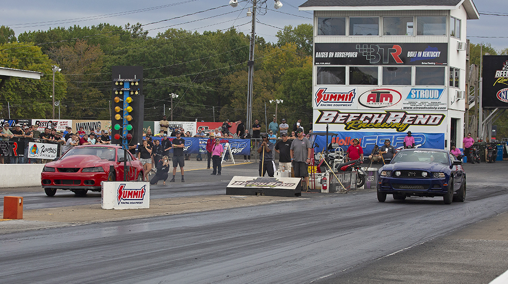 A 1999 Ford Mustang and a 2014 Ford Mustang drag race at Beech Bend Raceway in Kentucky