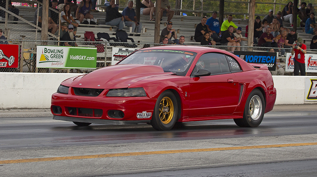 A red 1999 Ford Mustang drag races at Beech Bend Raceway in Kentucky