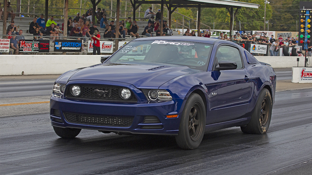A 2014 Ford Mustang drag races on the dragstrip at Beech Bend Raceway in Kentucky