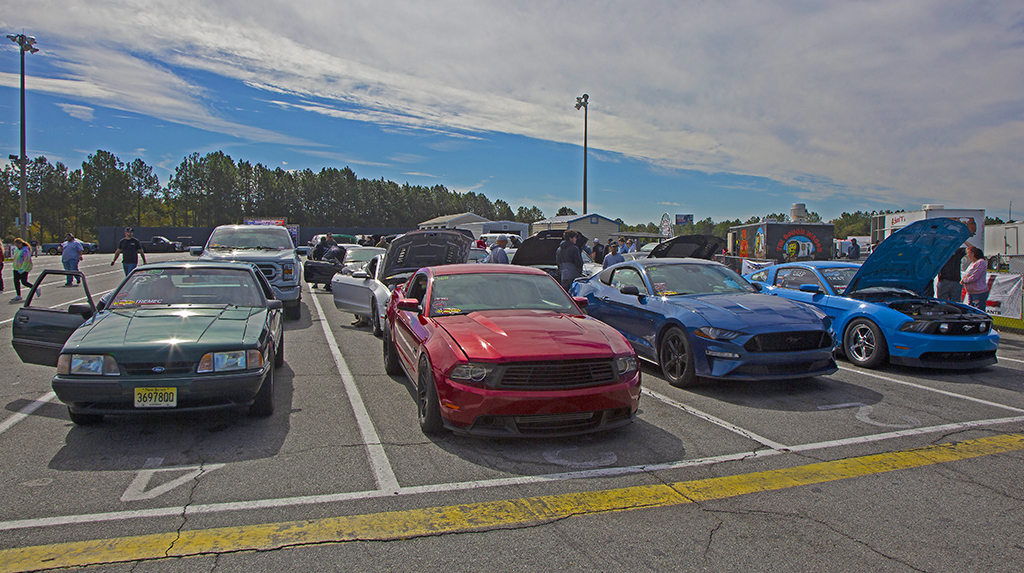 Ford Mustangs of different years and generations line up in the staging lanes at the South Georgia Motorsports Park dragstrip to cool down before their time trial runs for the True Street class