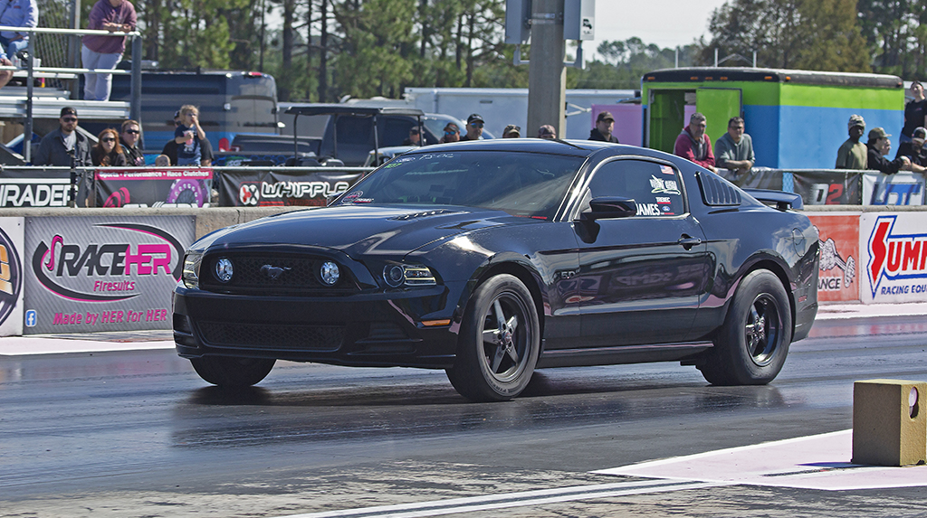 John Muldowney drag races his black S197 Ford Mustang GT during the 2026 Mod Motor Nationals in the True Street class
